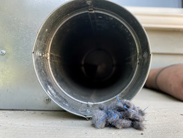 Bradenton Dryer Vent Cleaning technician using specialized equipment to clear severe dryer vent blockage in Bradenton